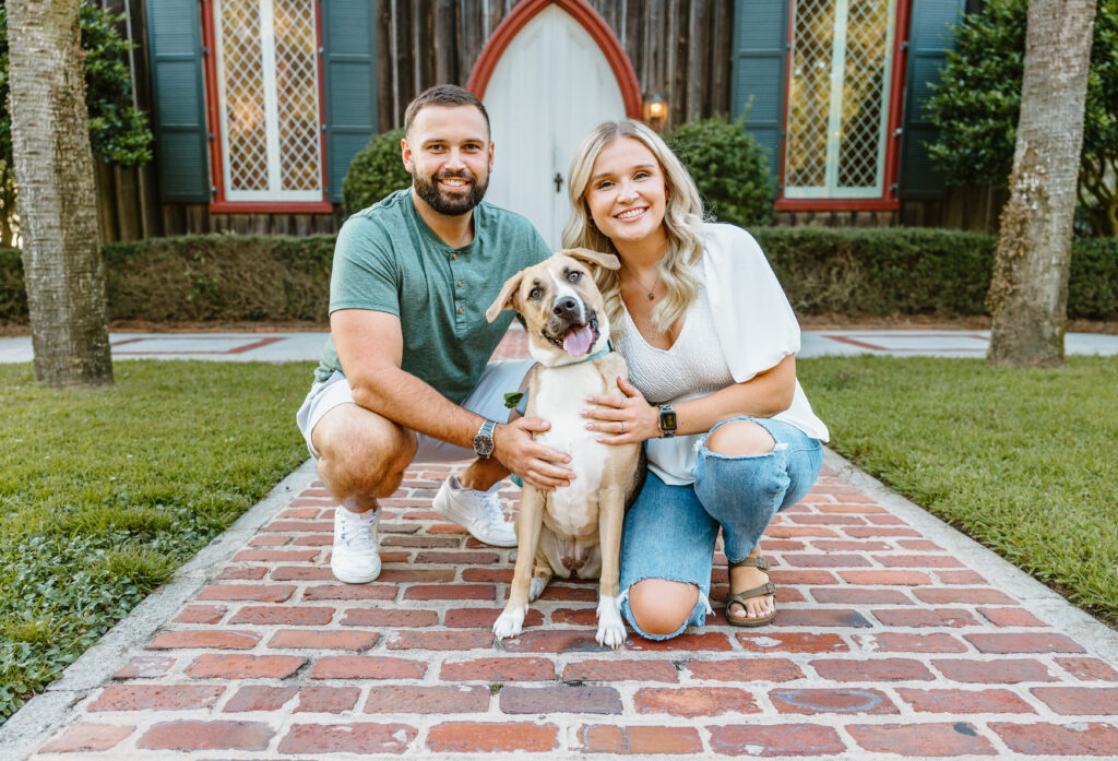 Couple with their dog in front of a historic church in Bluffton, SC.