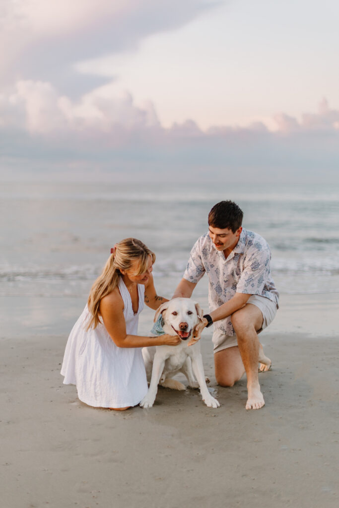 A couple on the beach with their dog